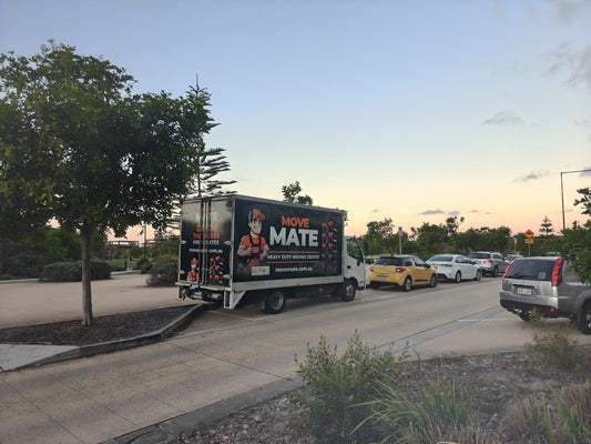 Move Mate truck parked on a suburban street at dusk
